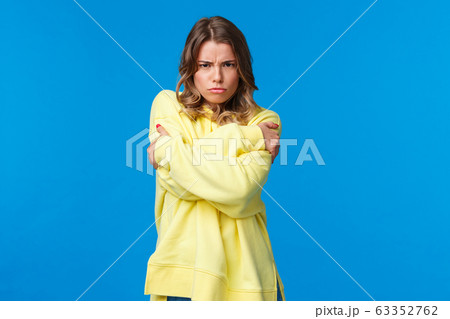 Dont come closer, I am mad at you. Upset and gloomy offended young woman hugging herself defensive and frowning angry at camera, feel insuted unwilling talk person 63352762