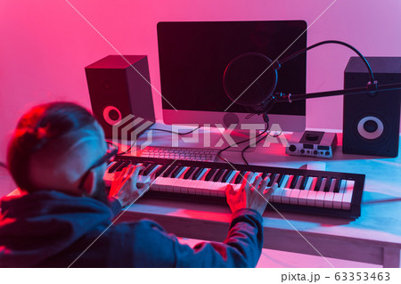Musician and making music concept - Male sound producer working in recording studio. Musician and making music concept - Male sound producer working in recording studio. 63353463