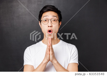 Close-up portrait of amused, enthusiastic young asian man hold hands in pray, clasp palms together as begging for something, asking for help or advice, say please, grateful for friend effort Close-up portrait of amused, enthusiastic young asian man hold hands in pray, clasp palms together as begging for something, asking for help or advice, say please, grateful for friend effort 63353540