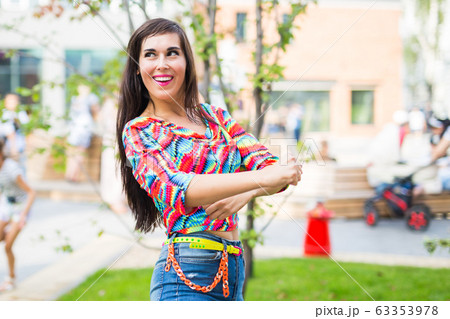 Street shaabi dance and urban dancer concept - Cheerful belly dancer dancing with arabic music on the street 63353978