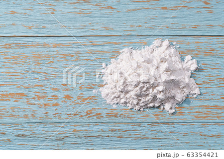 Pile of potato starch  on a wooden table. Top 63354421