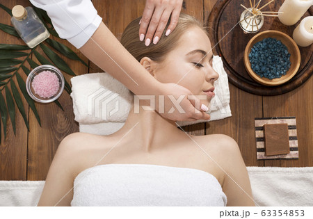 Masseur doing spa massage for millennial girl 63354853