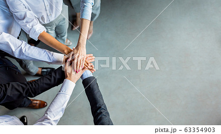 Unrecognizable Business People Holding Hands Standing In Modern Office, Above-View 63354903