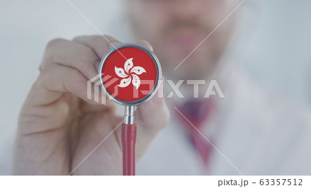 Physician uses stethoscope with the flag. Healthcare in Hong Kong 63357512