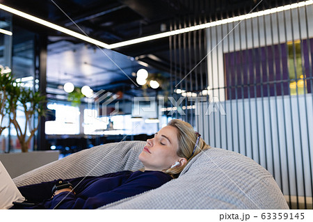 Caucasian woman chilling in a bean bag Caucasian woman chilling in a bean bag 63359145