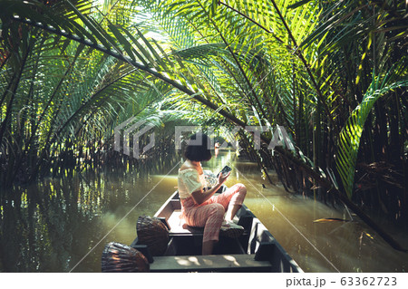 Travel on a wooden boat in the floating market. Travel on a wooden boat in the floating market. 63362723