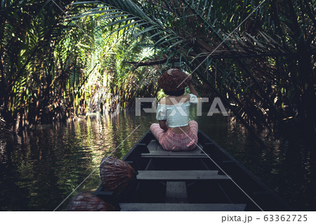 Travel on a wooden boat in the floating market. Travel on a wooden boat in the floating market. 63362725
