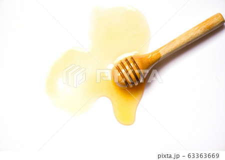 Wooden dipper honey yellow sweet on white 63363669