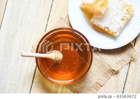 Fresh sweet honey in jar with wooden dipper and 63363672