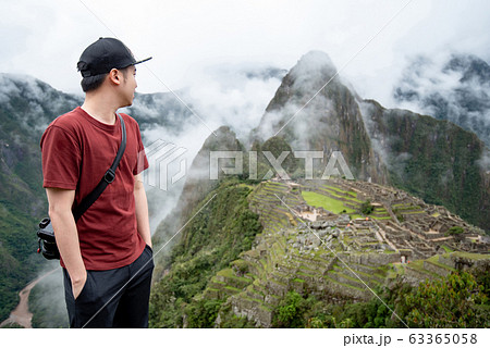 Young Asian man traveler looking at Machu Picchu 63365058