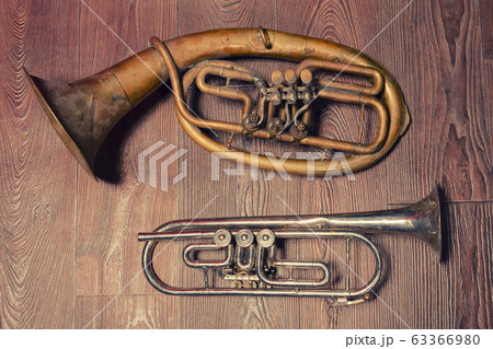 old brass wind instrument and horn  on a wooden 63366980