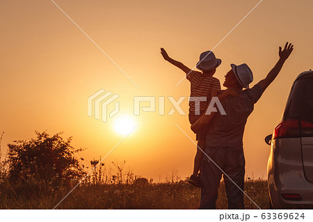 Father and son playing in the park at the sunset Father and son playing in the park at the sunset 63369624