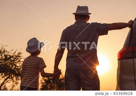 Father and son playing in the park at the sunset Father and son playing in the park at the sunset 63369628