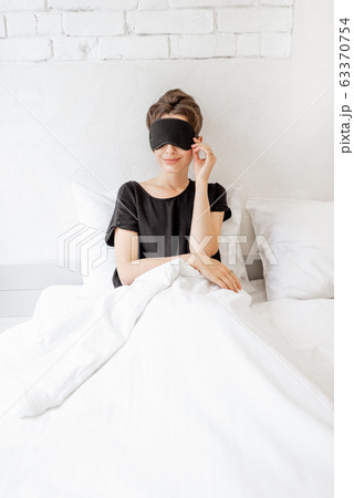 Woman waking up in bed Woman waking up in bed 63370754