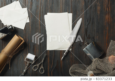 Old fashioned flat lay with letters writing accessories on dark wooden background Old fashioned flat lay with letters writing accessories on dark wooden background 63371233