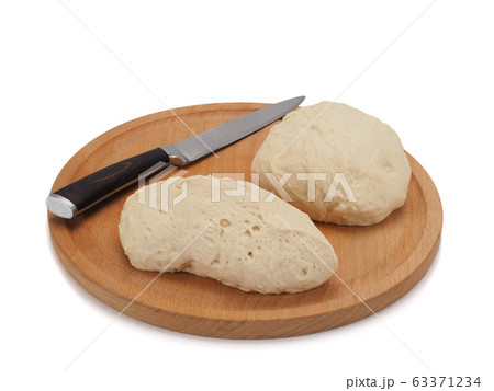 fresh raw sliced dough on wooden board isolated on white background 63371234