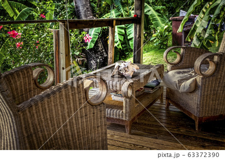 wooden terrace with chairs in a tropical garden wooden terrace with chairs in a tropical garden 63372390