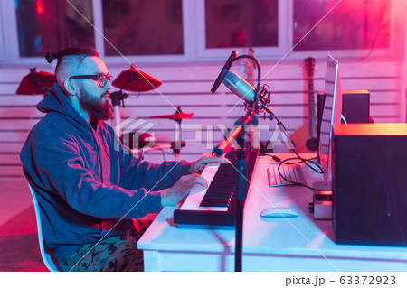 Professional musician recording synthesizer in digital studio at home, Music production technology concept. Professional musician recording synthesizer in digital studio at home, Music production technology concept. 63372923