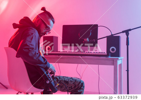 Musician and making music concept - Male sound producer working in recording studio. 63372939