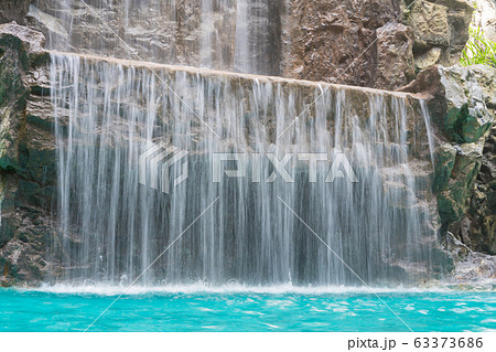 landscape of beautiful Artificial waterfall in garden at the public park. 63373686