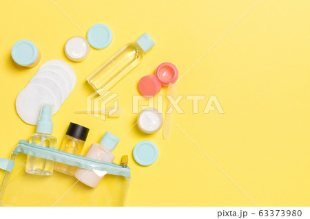 Group of small bottles for travelling on yellow Group of small bottles for travelling on yellow 63373980