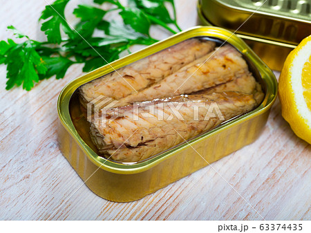 Salty fillet of mackerel in sunflower oil in open tin can Salty fillet of mackerel in sunflower oil in open tin can 63374435
