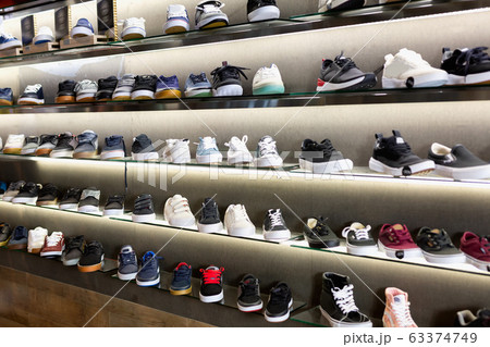 Variety of men and unisex sneakers in modern shoe shop 63374749