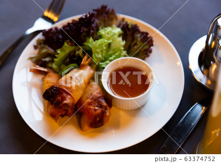 Fried spring rolls with vegetables and shrimps with sauce and salad Fried spring rolls with vegetables and shrimps with sauce and salad 63374752