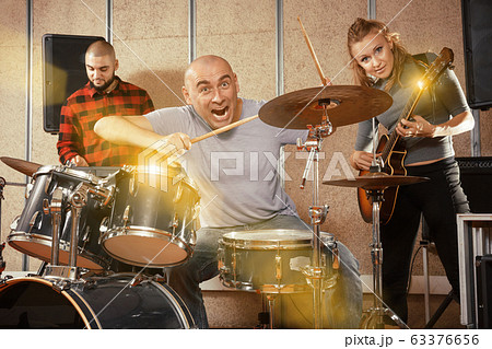 Garage band rehearsing in studio 63376656