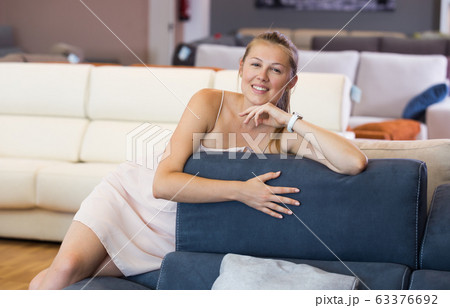 woman buyer sitting on sofa with pillow woman buyer sitting on sofa with pillow 63376692