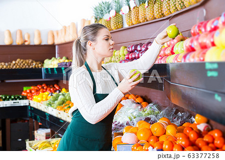 woman selling fresh apples and other fruits 63377258