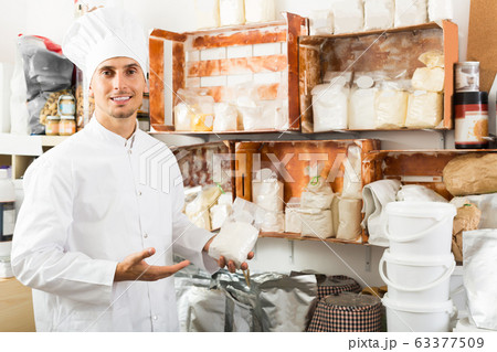 Portrait of male cook standing with groats Portrait of male cook standing with groats 63377509