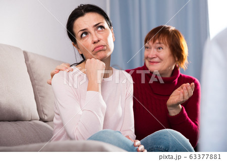 Portrait upset female looking away after conflict, mother talking Portrait upset female looking away after conflict, mother talking 63377881