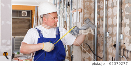 Plumber preparing plastic pipes for installation Plumber preparing plastic pipes for installation 63379277