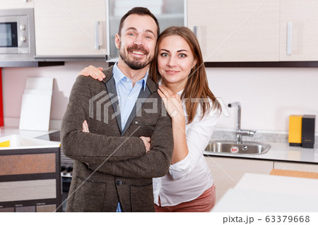 Pair of young people in furniture accessories shop 63379668