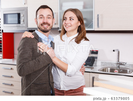 Pair of young people in furniture accessories shop Pair of young people in furniture accessories shop 63379805