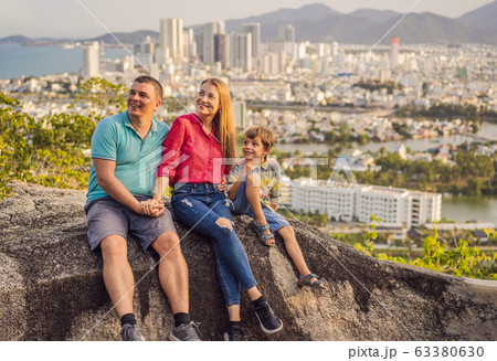 Happy family tourists on the background of Nha Trang city. Travel to Vietnam with kids Concept Happy family tourists on the background of Nha Trang city. Travel to Vietnam with kids Concept 63380630
