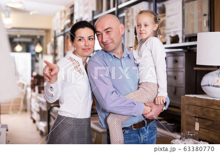 Family is choosing new furniture Family is choosing new furniture 63380770