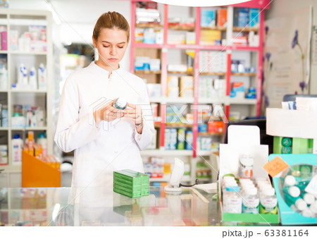 Woman pharmacist working in pharmaceutical shop Woman pharmacist working in pharmaceutical shop 63381164