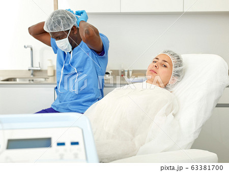 Female in armchair before facial procedure in clinic of esthetic cosmetology 63381700