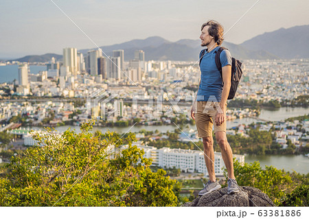 Man tourist on the background of Nha Trang city. Travel to Vietnam Concept Man tourist on the background of Nha Trang city. Travel to Vietnam Concept 63381886
