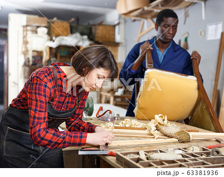 Restorers working with wooden furniture Restorers working with wooden furniture 63381936