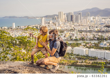 Dad and son tourists on the background of Nha Trang city. Travel to Vietnam with kids Concept Dad and son tourists on the background of Nha Trang city. Travel to Vietnam with kids Concept 63382261