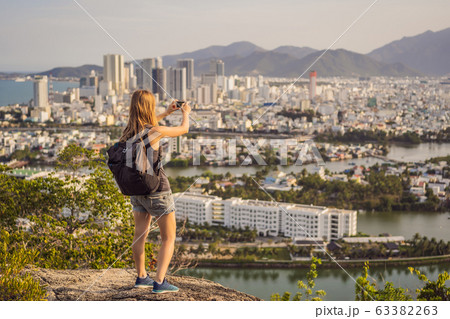 Woman tourist on the background of Nha Trang city. Travel to Vietnam Concept 63382263