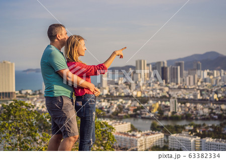 Happy couple tourists on the background of Nha Trang city. Travel to Vietnam Concept Happy couple tourists on the background of Nha Trang city. Travel to Vietnam Concept 63382334