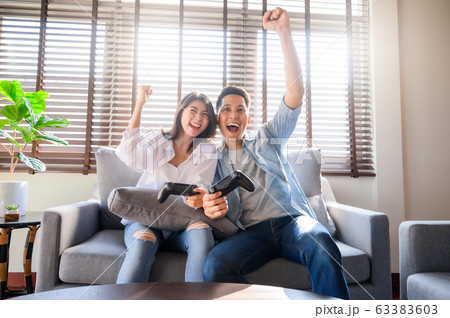 Couple having a good time playing video game Couple having a good time playing video game 63383603