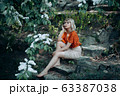 Beautiful sitting woman enjoying nature, pretty girl relaxing outdoor. 63387038