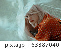 Portrait. Beautiful lying woman enjoying daisy field, pretty girl relaxing outdoor. Close-up 63387040