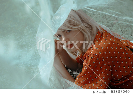 Portrait. Beautiful lying woman enjoying daisy field, pretty girl relaxing outdoor. Close-up 63387040