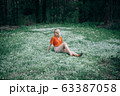 Beautiful woman enjoying daisy field, pretty girl relaxing outdoor 63387058